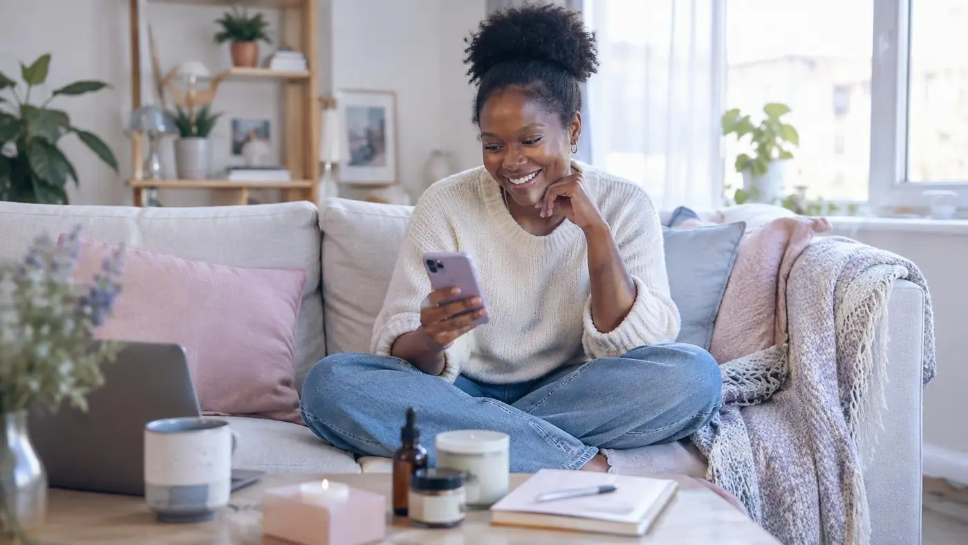 A lifestyle brand founder delighted by something on her phone