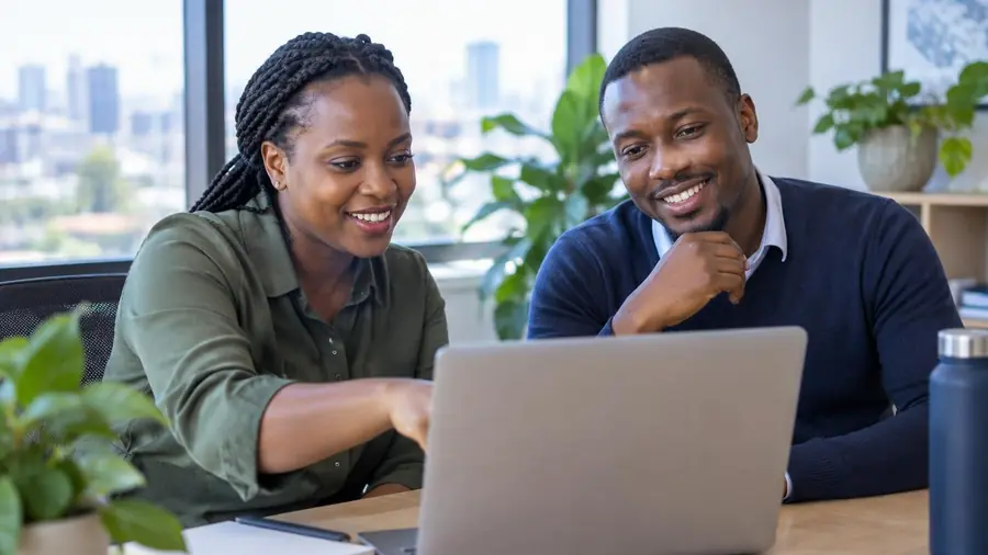 Two colleagues in Nairobi pleased with results on a laptop